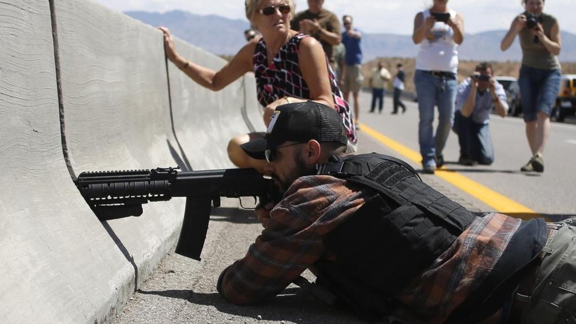 Protester Eric Parker of Hailey aims his weapon from a bridge next to the Bureau of Land Management’s base camp, where seized cattle that belonged to rancher Cliven Bundy were being held in April 2014 near Bunkerville, Nev.