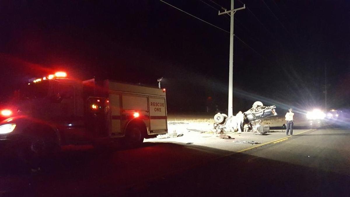 Emergency personnel work to remove the body of Nyssa resident Billy Jo Carr Jr., after he flipped his pickup trying to avoid collision with an SUV or hatchback car that came into his lane while trying to pass another vehicle on Highway 20.