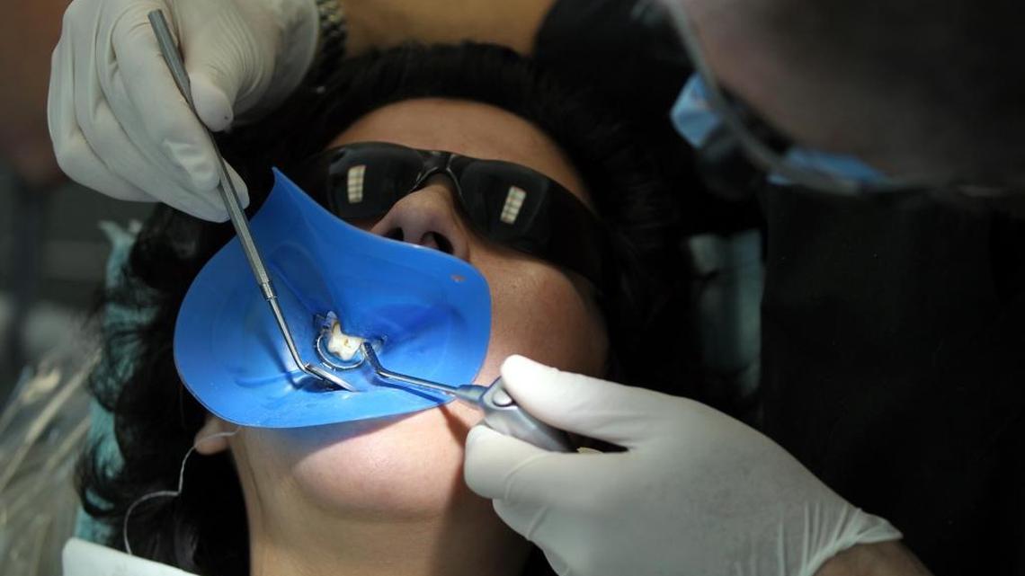A Fruitland woman is in federal prison for practicing dentistry for years without a license in Payette. Here, a dentist removes a filling.