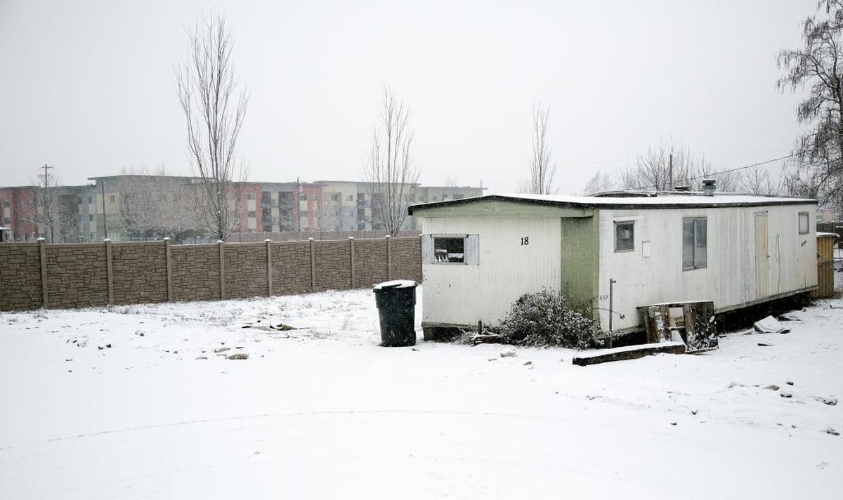 An abandoned mobile home last December at Tammy’s Riverside Park in Garden City, with the new Trailwinds apartments development in the the background. The mobile home is now gone.