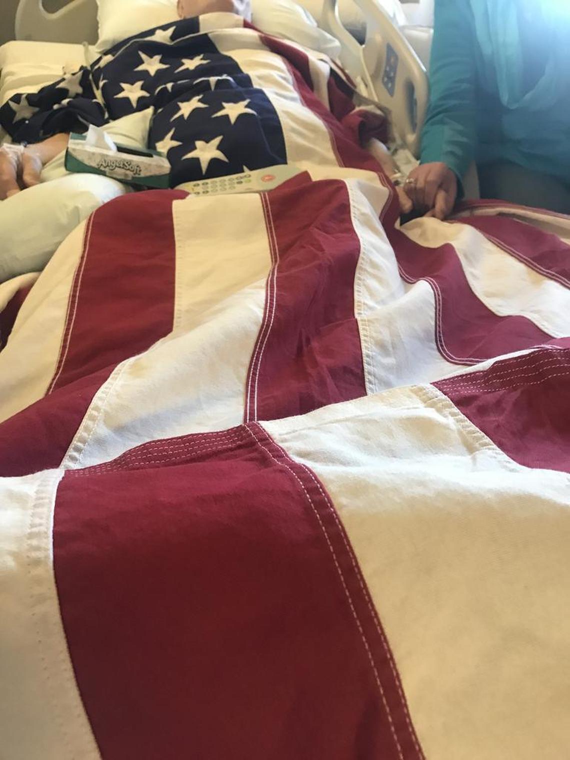 Mildred Kissée holds the hand of her husband, Marvin, in the hospital. Marvin Kissée, a veteran of two wars, died from complications from the flu Sunday.