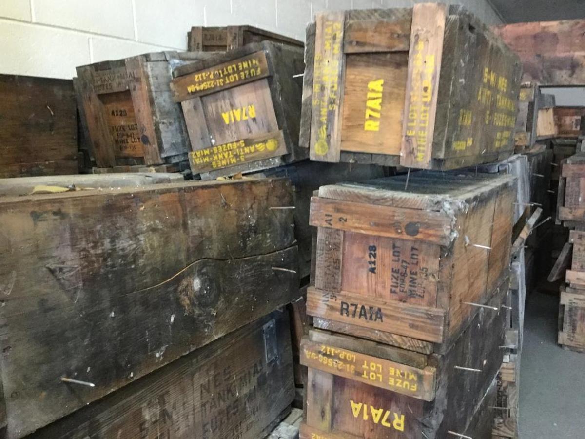 The old wooden boxes found inside a wall of a Garden City building once held anti-tank mines. Now their new owner, Colby Patchin, who found them on his property, is eager to find collectors who might be interested in the boxes.