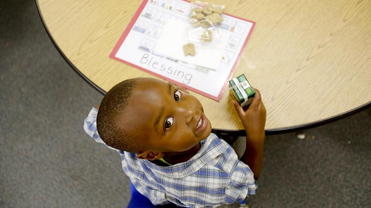Blessing Ngabontiza with his morning snack at the new pre-K program at Hawthorne Elementary School in Boise. Officials will be testing students to see how they do when they get to kindergarten.
