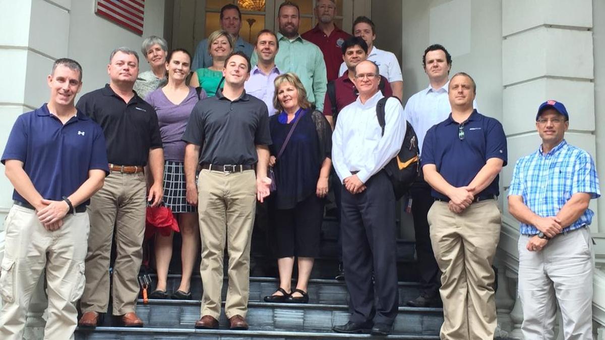 Students and faculty in Boise State University’s executive MBA program with officials of the U.S. government’s MIA/POW office in Hanoi on the office’s steps.