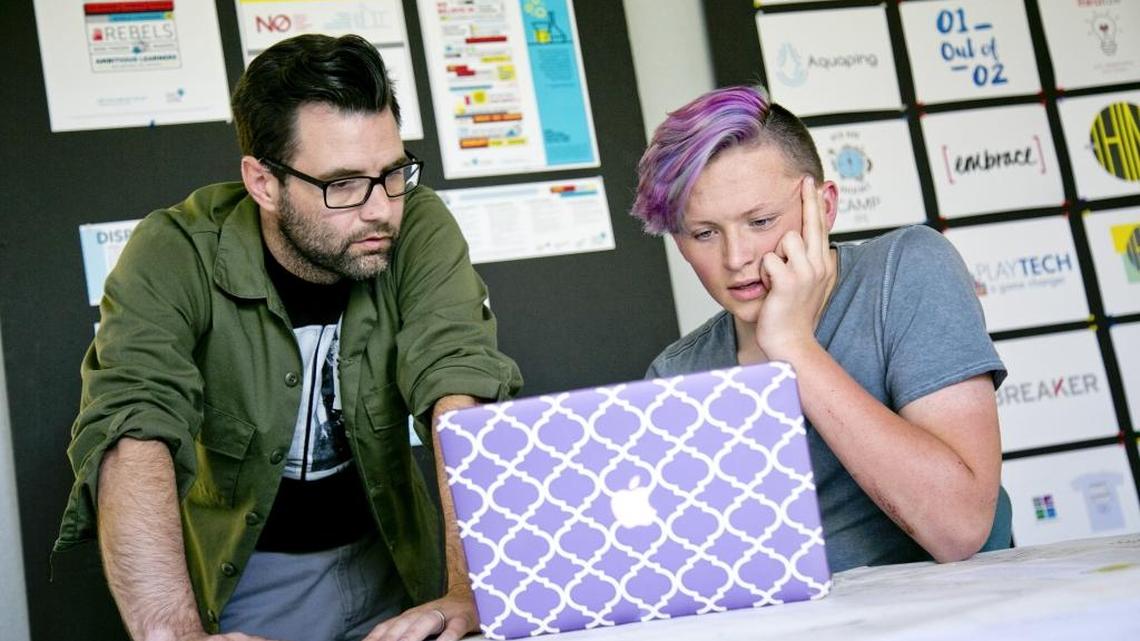 Michael Reagan, creative director for Two Birds, an advertising agency part of One Stone, mentors Hayden Irish with a project., Two Birds allows students to work with real-world clients on web, advertising and branding projects.