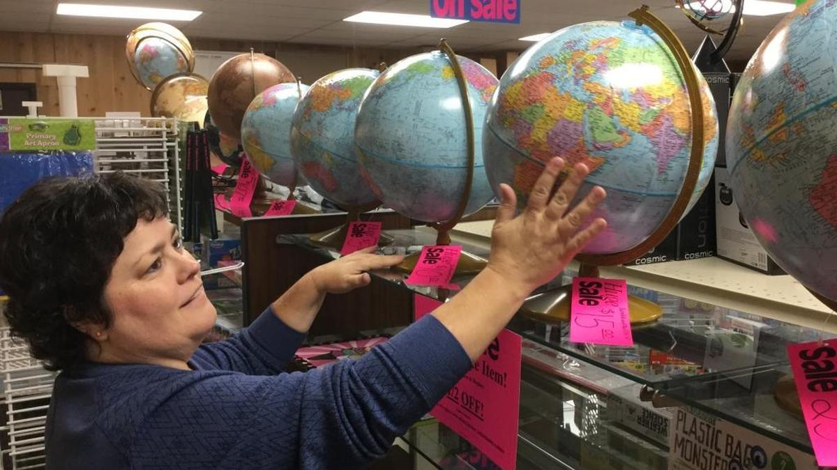 Store manager Tammie Barnett surveys the Idaho School and Book Supply collection of world globes. The store, opened in 1972, has provided all kinds of educational materials, from workbooks to pencils and stickers, to teachers and families.