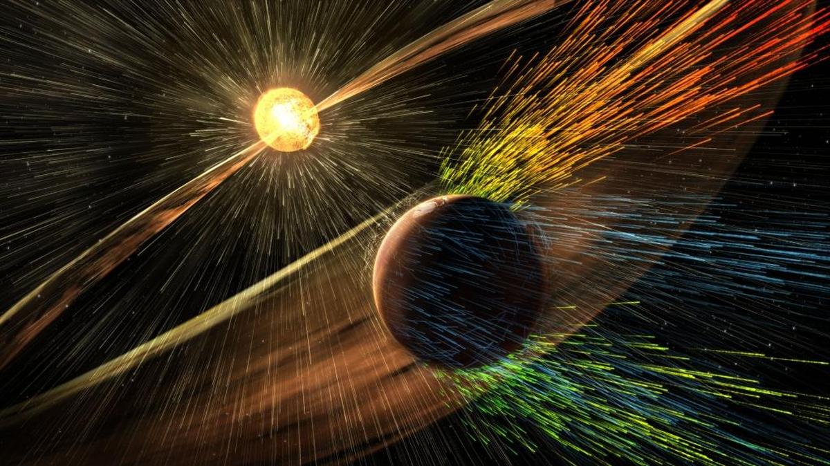 An artist’s rendering of a solar storm hitting the planet Mars and stripping ions from the planet’s upper atmosphere.