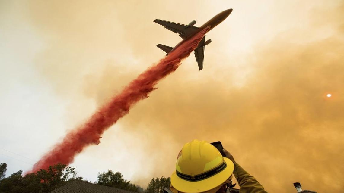 An air tanker drops fire retardant while battling a wildfire that forced thousands of people to evacuate their homes near Mariposa, Calif., July 19, 2017.