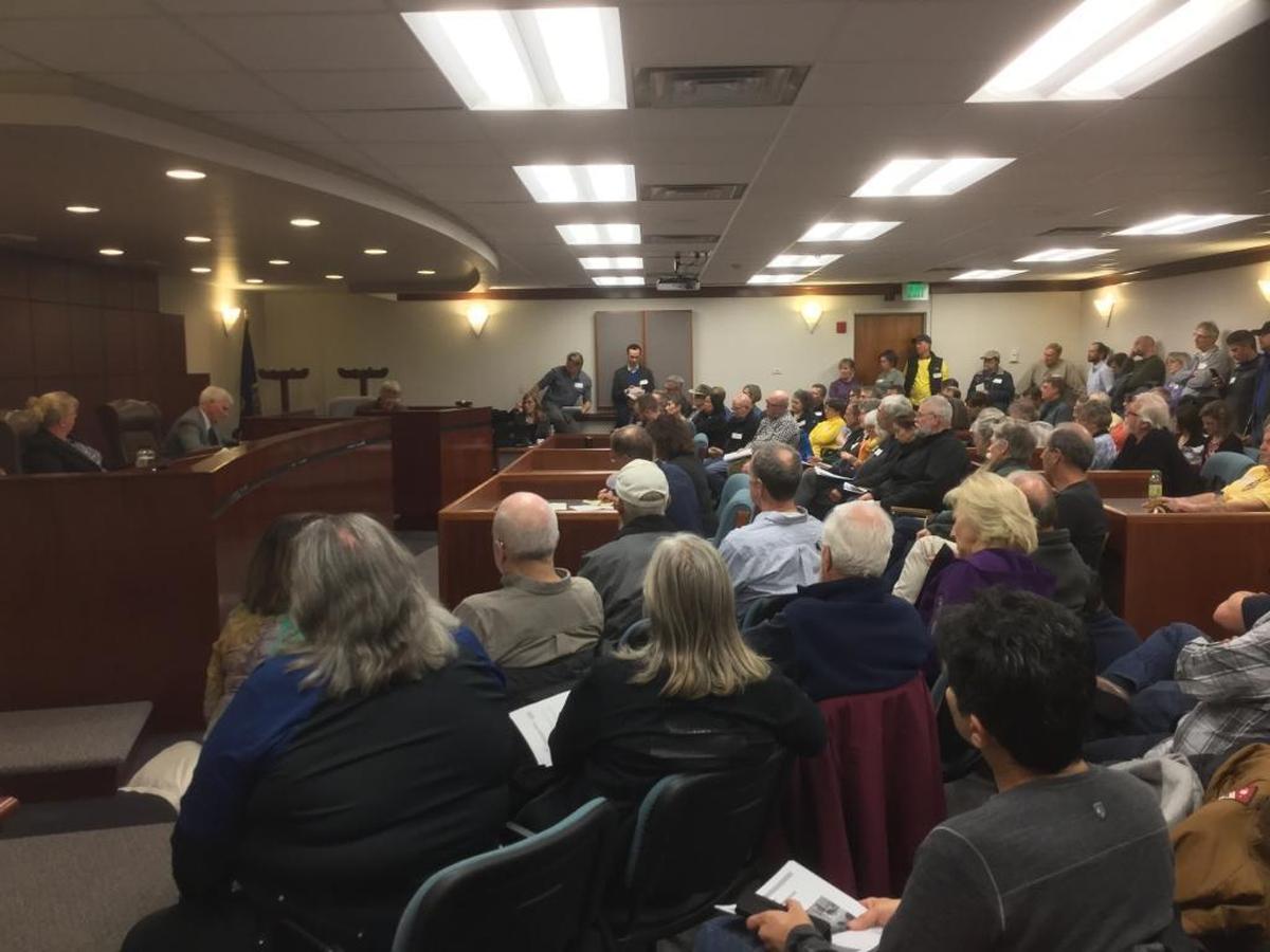 Idaho Power customers overflow the Idaho Public Utility Commission's Boise hearing room in 2018 to protest the utility's proposal to place solar customers and others who export electricity onto the grid into a separate rate class.