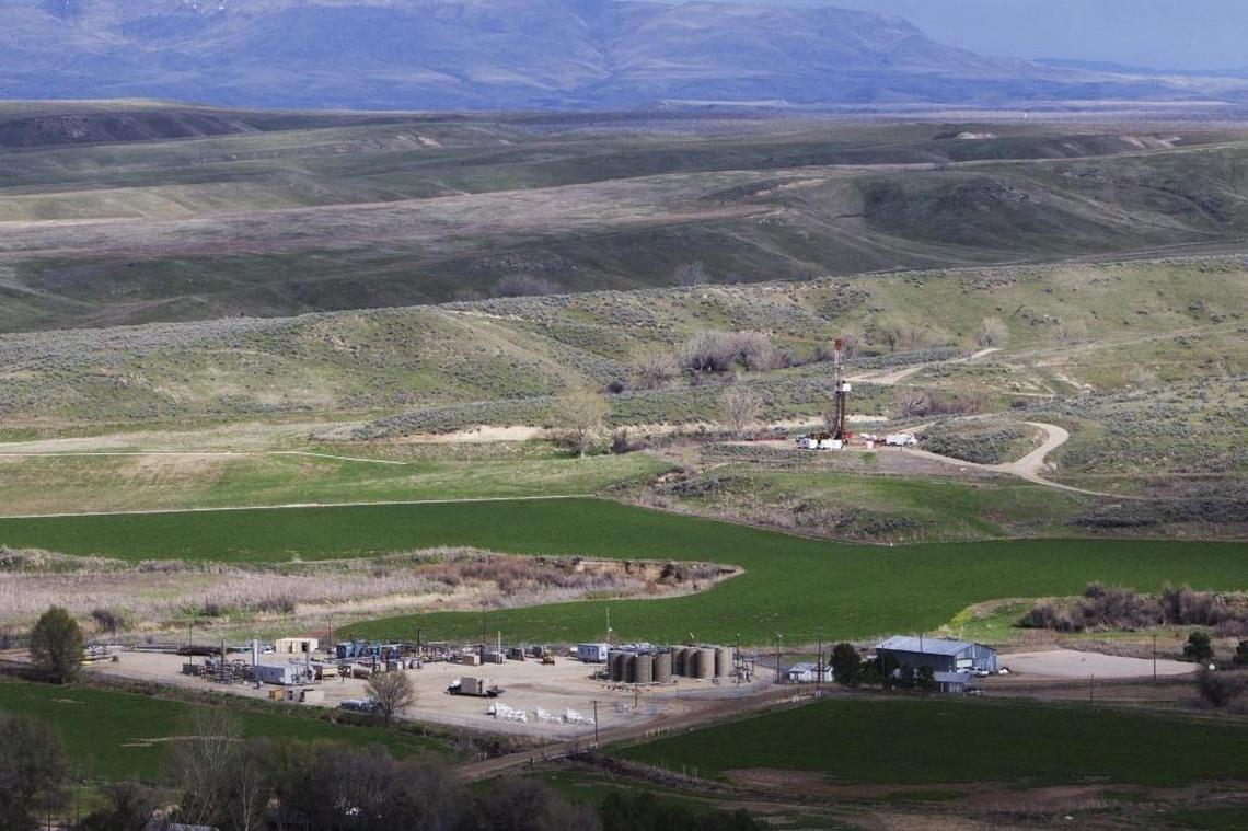 From a vantage point above an oil and gas processing center, about a half dozen drilling and pump developments can be seen over an oil field east of Payette.