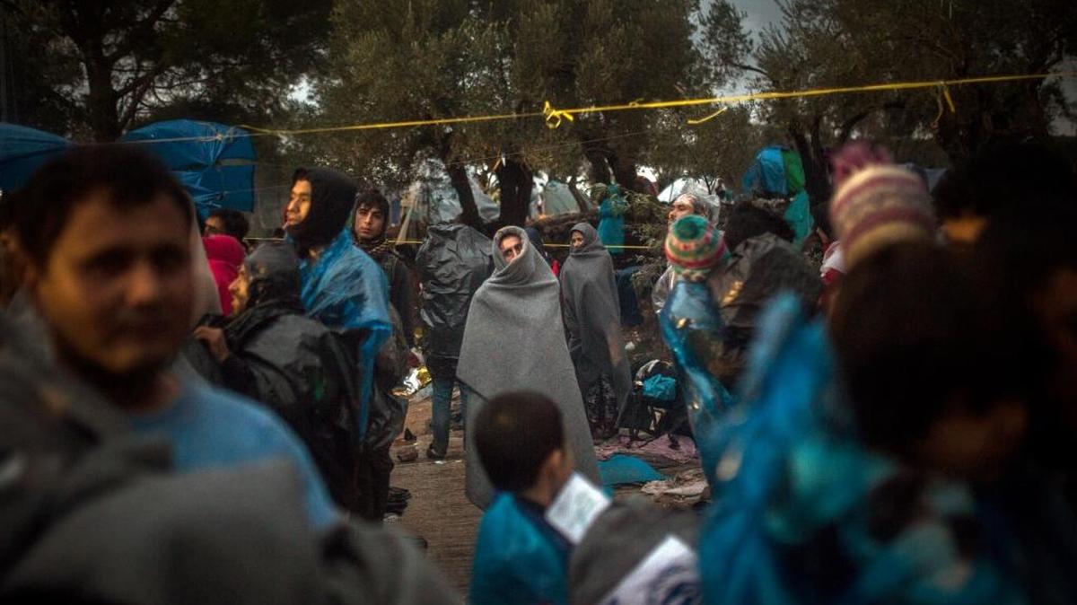 Migrants wait to register themselves in Moria village on the Greek island of Lesbos Oct. 24.