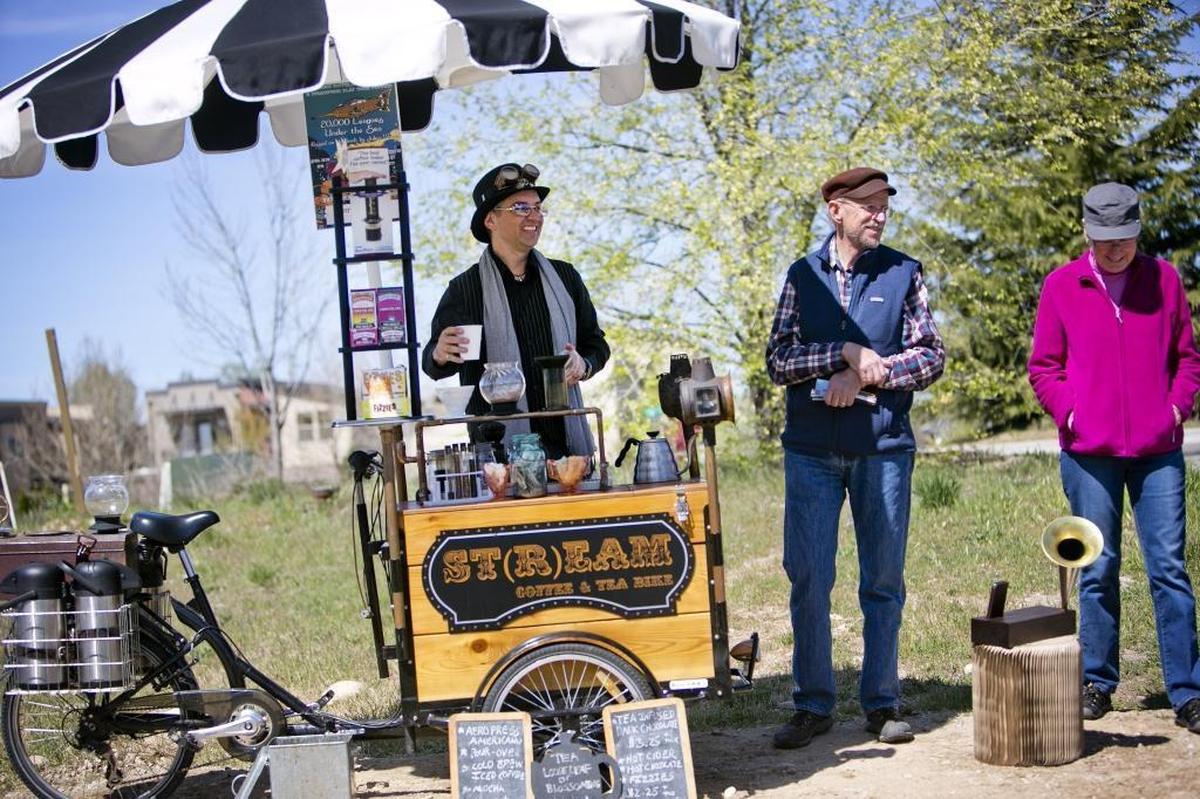Jodi Eicheberger, left, owns the St(r)eam Coffee & Tea Bike. He serves a coffee pour-over and hot chocolate for customers Kenny and Valerie Cobbs near the 36th Street footbridge on the Boise Greenbelt. Eichelberger is a puppeteer and actor working to enhance culture in his Garden City neighborhood with bike tours and a group effort to buy properties to limit gentrification.