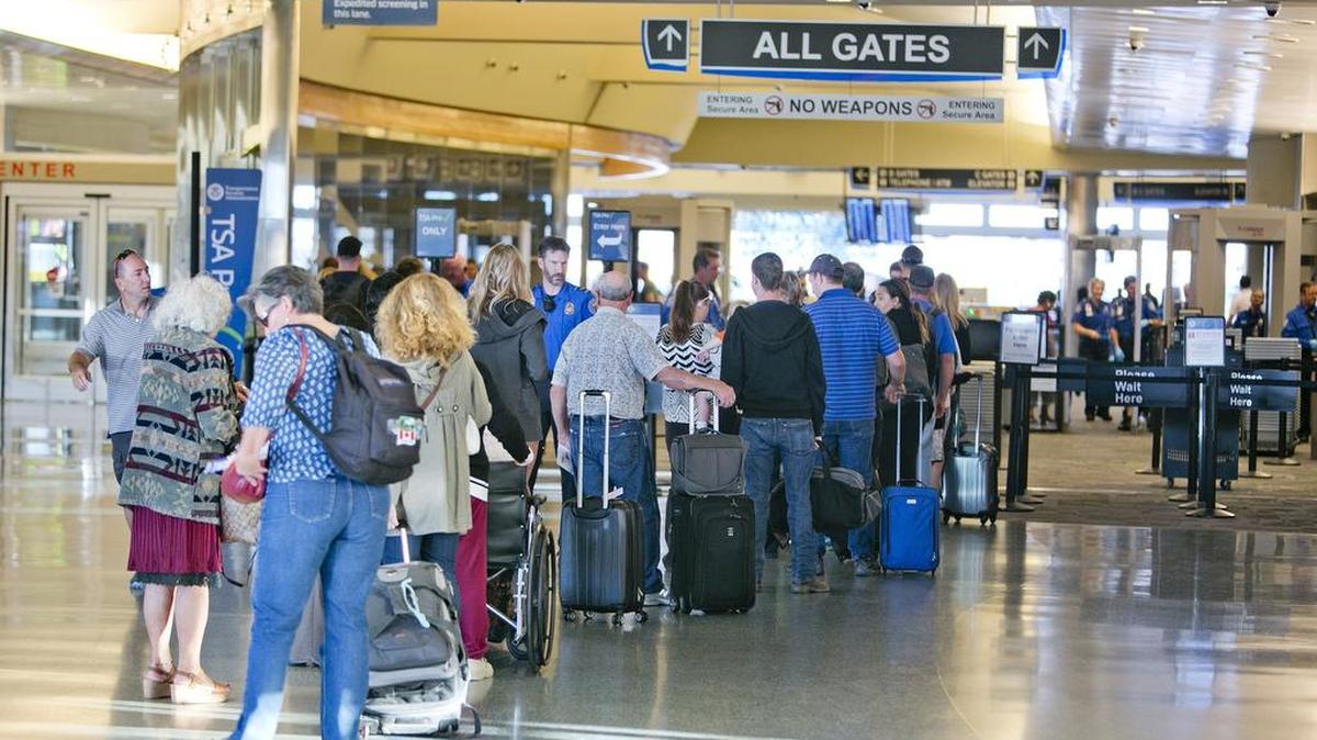 Travelers wait at the Transportation Security Administration’s security-check area of the Boise Airport in September.