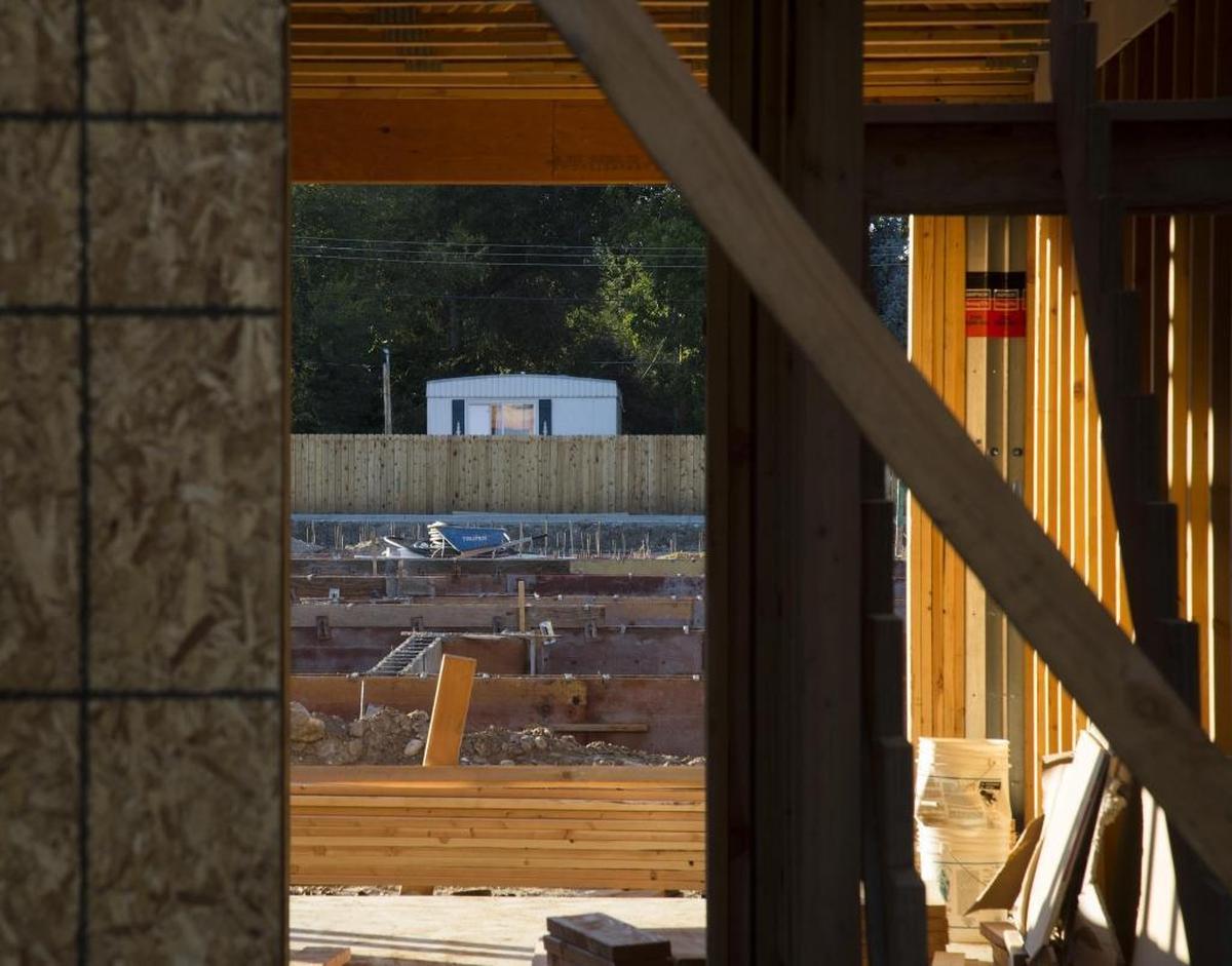 Contruction is reshaping the Adams Street neighborhood. New townhomes rise near old mobile homes.