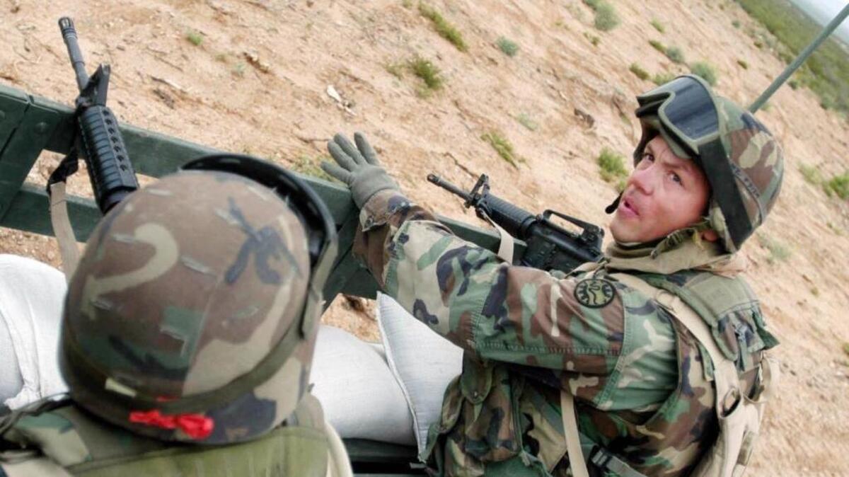 Sgt. Joseph Frye, of Nampa, discusses a situation with a safety officer on the truck during a convoy into a live fire exercise Saturday morning. After a morning training and shooting at targets of insurgents, the conversation turned to the kinds of vehicles they drove when they were home. "My sister’s been using my truck to go ‘yard salin',’ " Frye admitted with a laugh.