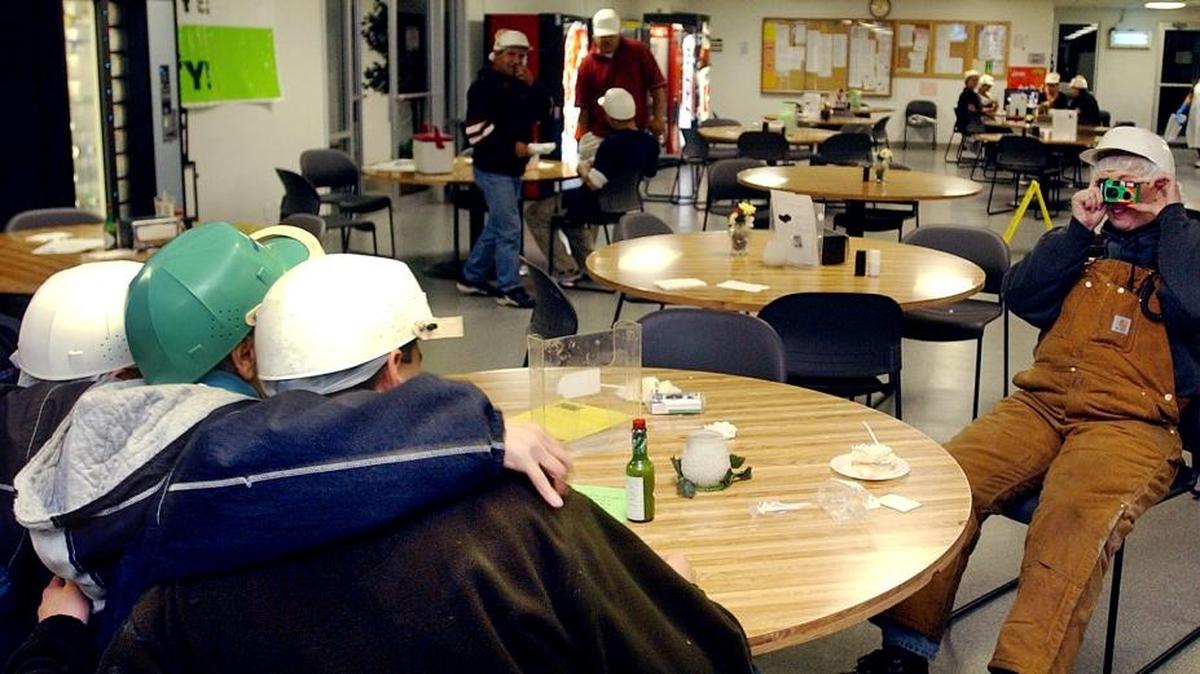 Robin Hutchinson takes a photo of her shift friends on break in the J.R. Simplot Co. lunchroom on her last night of work in October 2002, as the first round of permanent layoffs hit the Heyburn processing plant. Simplot provided cake and ice cream, disposable cameras and address books to employees on their last few days of work.