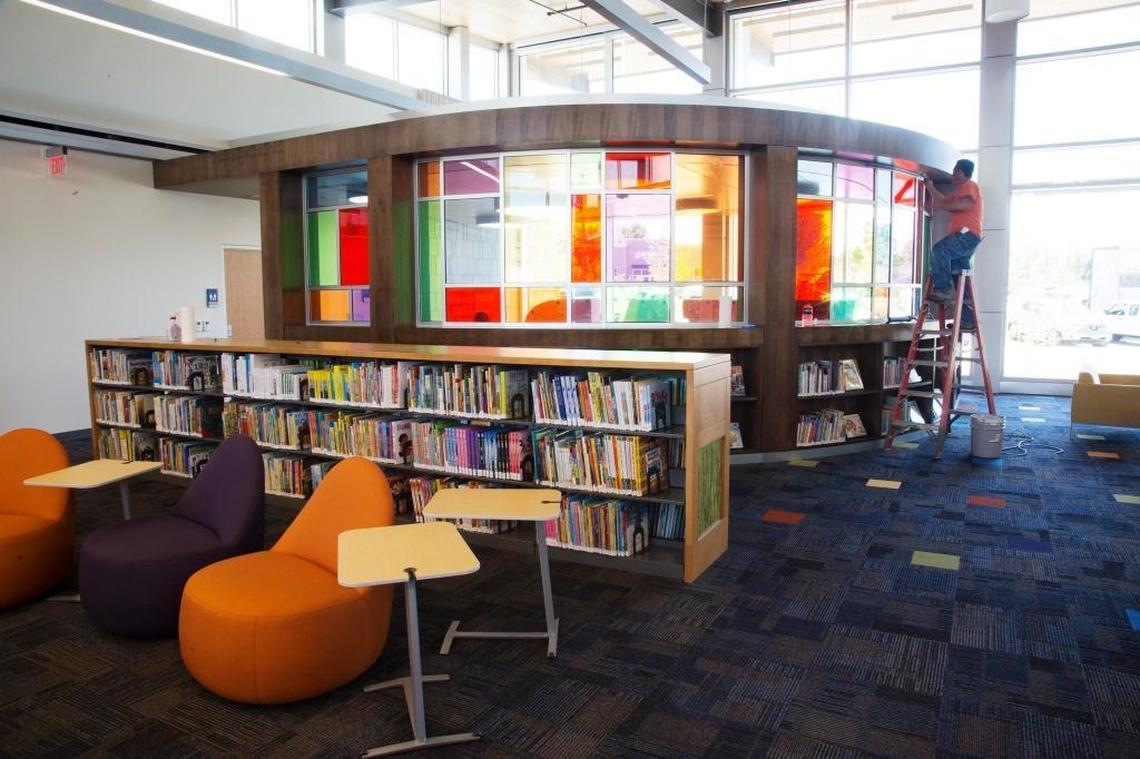 The Bown Crossing Library branch offers an area for children that’s enclosed by a bright wall of multi-colored glass.