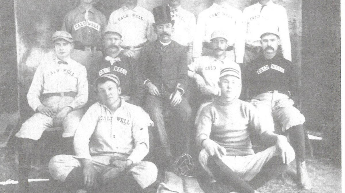 Manager Charles Reed poses proudly with his Caldwell “Champions of Idaho.”