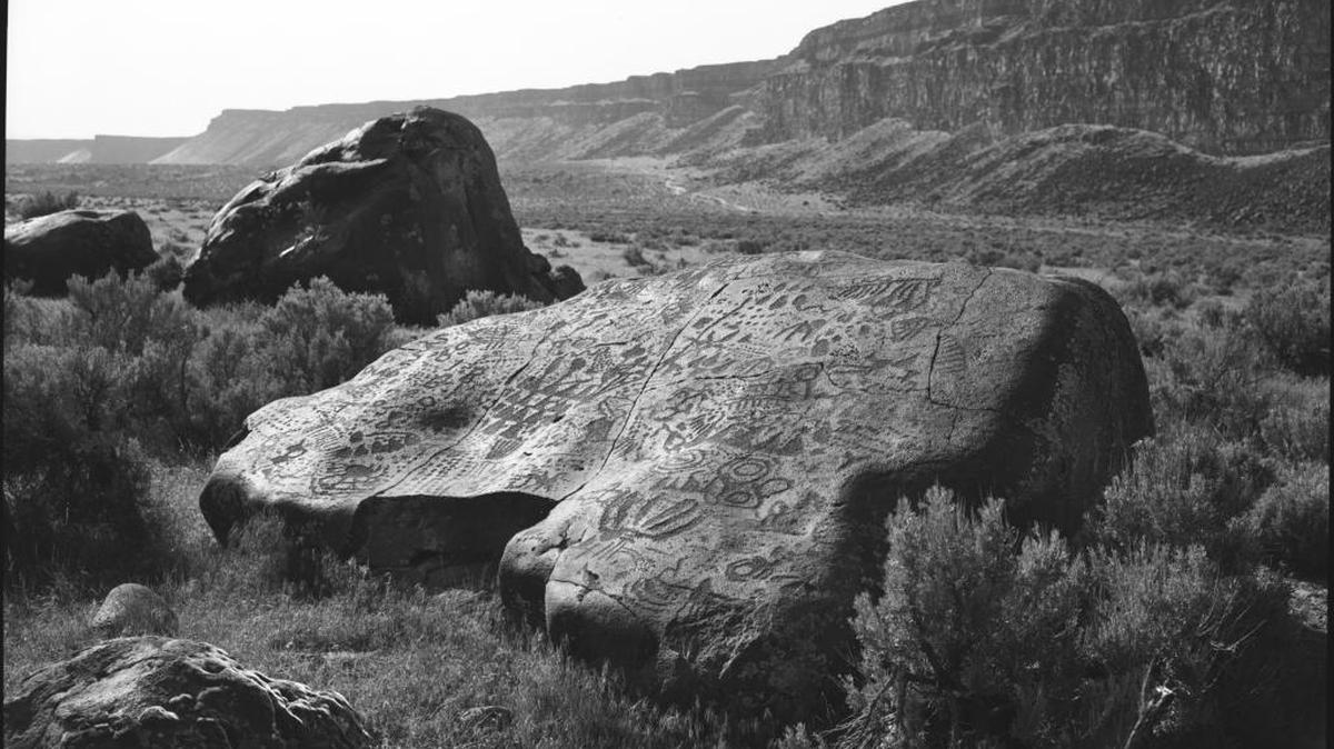 “Boulder #7, Wees Bar Petroglyph Field, 1974,” a black and white photograph by Jan Boles. Wees Bar is on the Snake River not far downstream from Swan Falls Dam in what is now the Morley Nelson Snake River Birds of Prey National Conservation Area. This photograph was part of “Reflections/Refractions,” an exhibition at the College of Idaho in 1984. It is emblematic of Boles’ photographic work.
