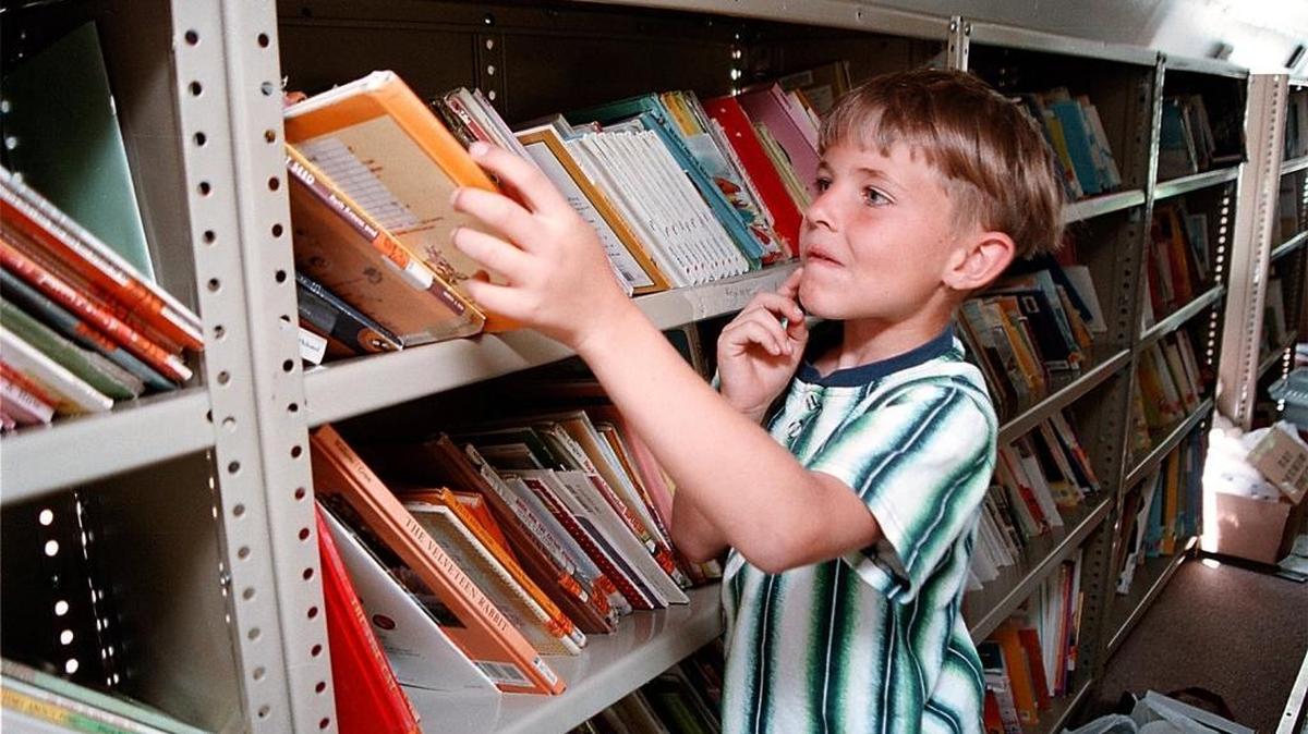 A young reader ponders his choices in the Bells for Books mobile library, a project of the Garden City Public Library. The program is the recipient of a $15,000 grant.