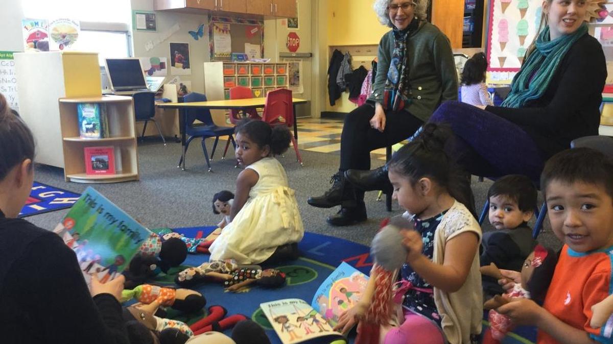 Sharon Katz (back, center) donated a new shipment of DiverseFamilies dolls to the Learning Lab recently, much to the delight of the center’s staff and students. Kids from all backgrounds can recognize themselves and their family members in the dolls.
