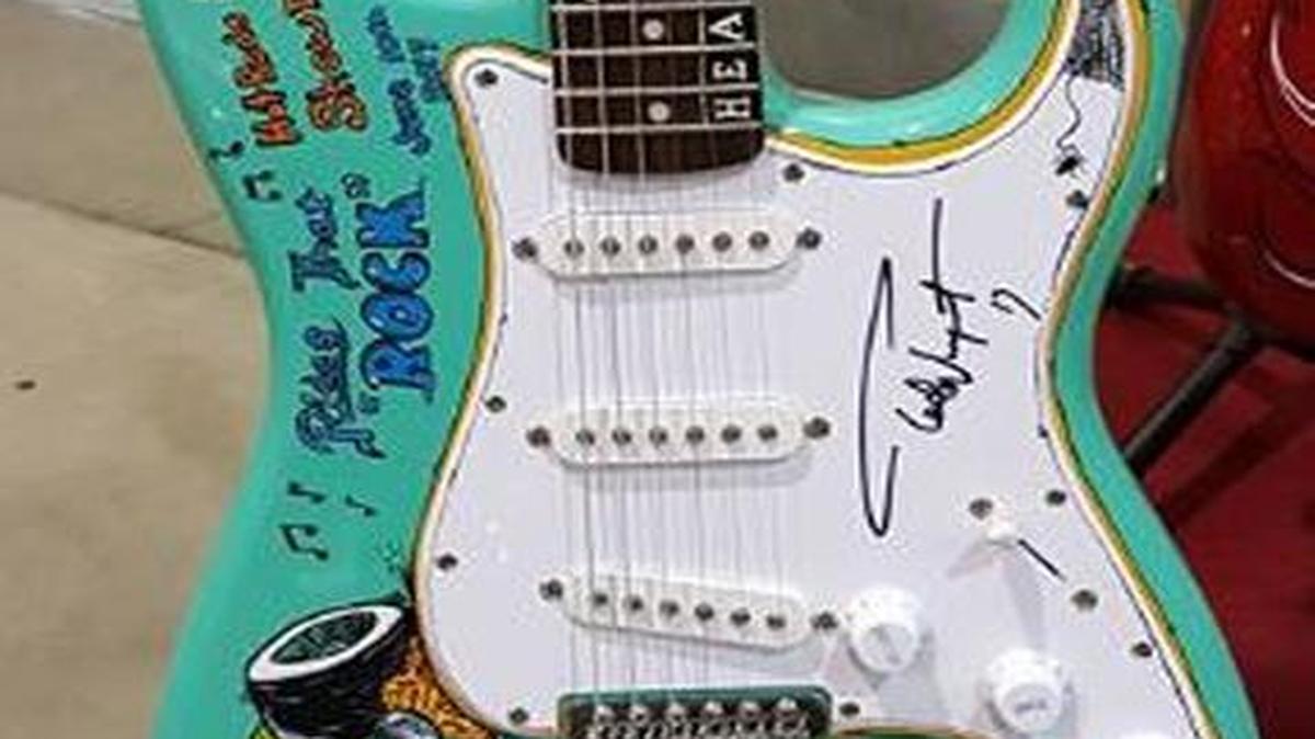 One of many awards is a customized electric guitar signed by Ted Nugent.