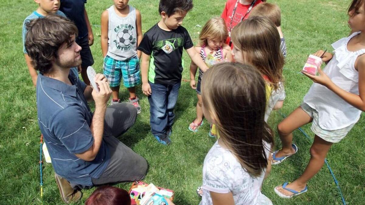 Volunteering is a big part of life for many Idahoans, according to a new study. Idaho ranks 5th in the nation for the percentage of its residents who give their time to causes they believe in. Shown here, volunteer Damien Burbine explaining the concept of atoms to kids in Lakeview Park in Nampa during a past Summer Literacy in the Park program.