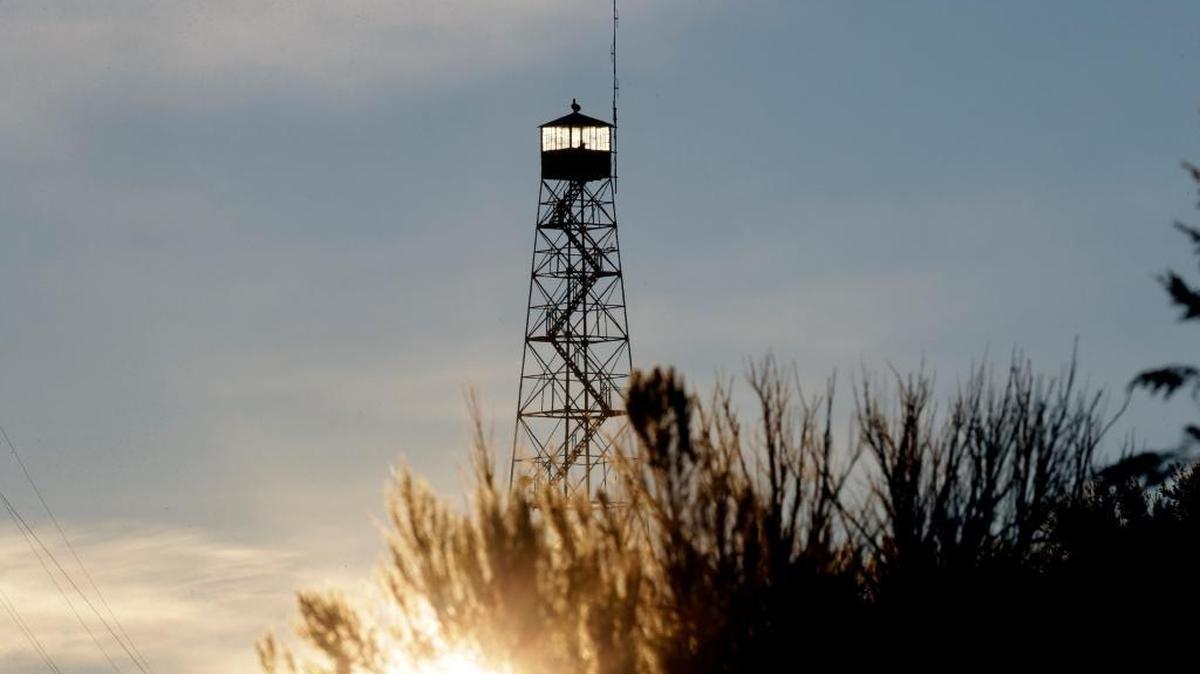 A man stands guard in a watch tower at sunrise at the Malheur National Wildlife Refuge near Burns, Ore., on Wednesday, Jan. 6.
