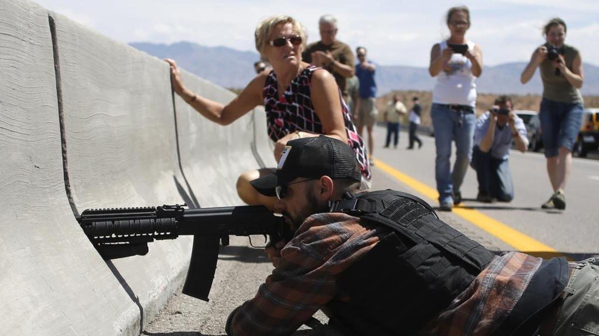 Protester Eric Parker from central Idaho aims his weapon from a bridge next to the Bureau of Land Management's base camp where seized cattle, that belonged to rancher Cliven Bundy, were being held April 12, 2014 near Bunkerville, Nevada.