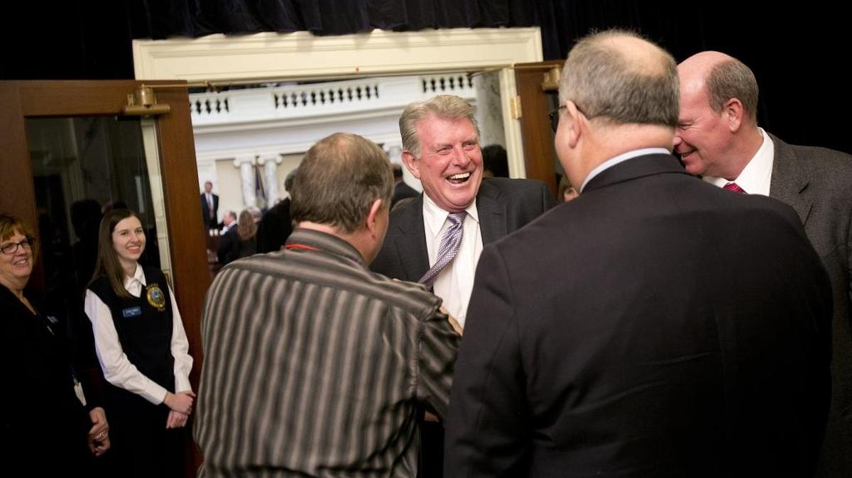 Idaho Gov. Butch Otter laughs as a microphone is removed from his tie Monday after his annual State of the State to open the 2016 Idaho Legislature at the Idaho States Capitol.