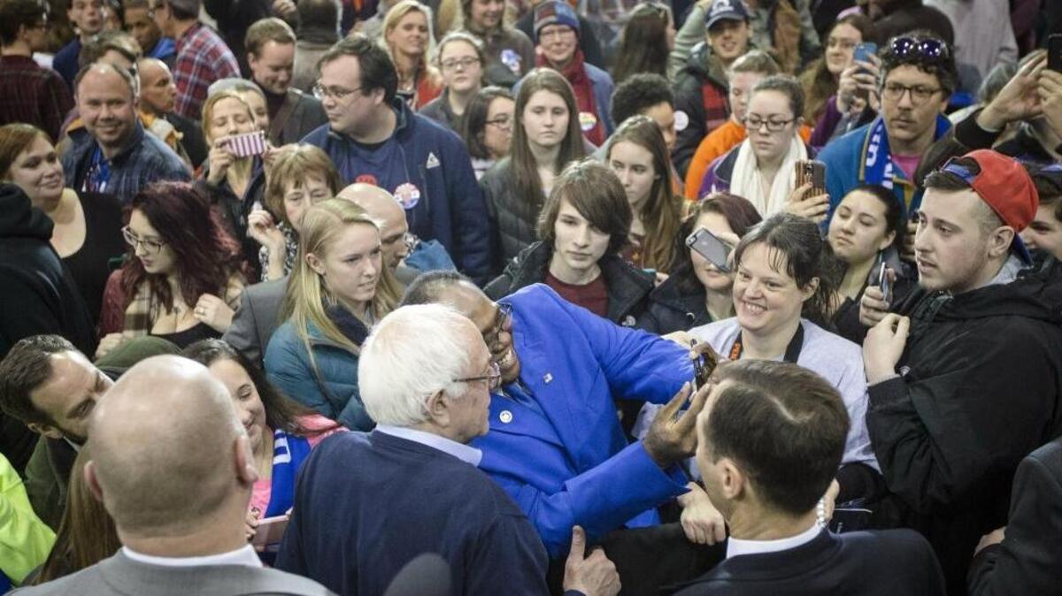 Democratic presidential candidate Sen. Bernie Sanders, I-Vt., has a picture taken with audience member Michael T. Brown, center, during a campaign stop at the Franklin Pierce University Fieldhouse, Feb. 6 in Rindge, N.H.