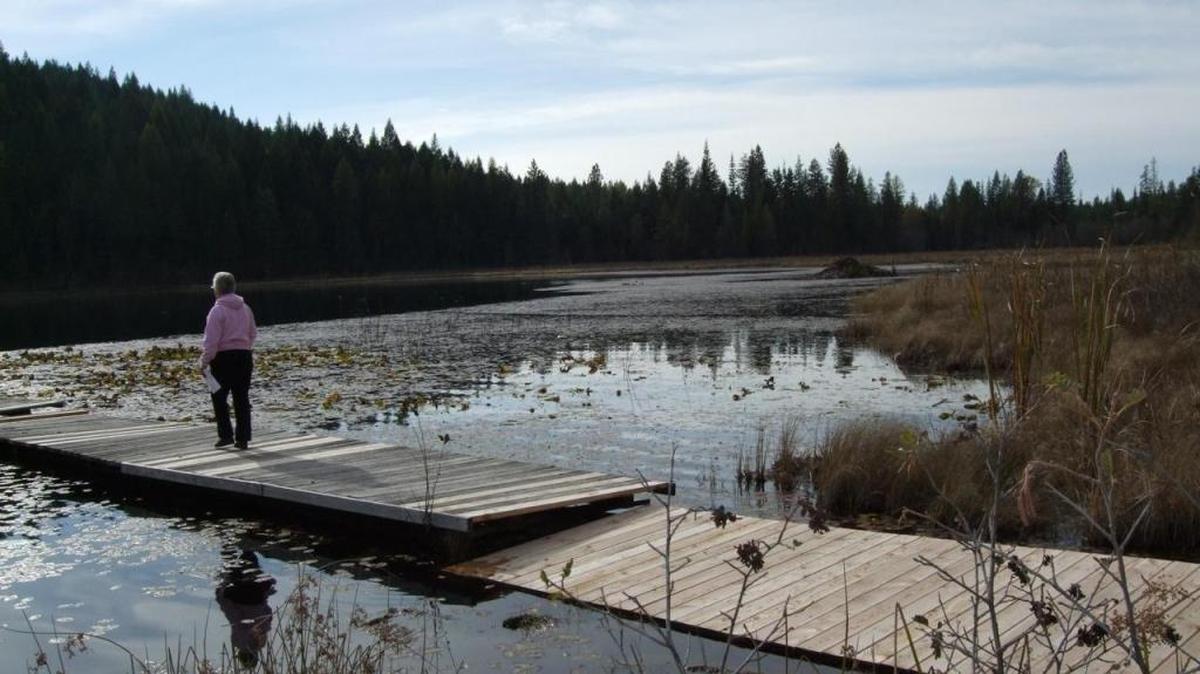 A homeowner checks out Lambertson Lake in what is known as Clagstone Meadows in rural Bonner County. The development's easement has come under attack from groups and lawmakers even though local residents and wildlife officials praise it.