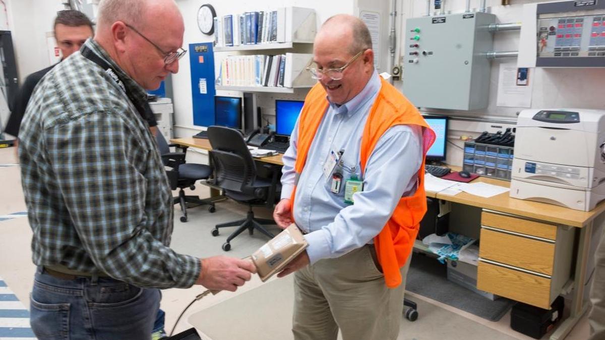 Jon Johnston uses an alpha radiation detector on Statesman reporter Rocky Barker after touring a glovebox room at INL's Fuel Manufacturing Facility.