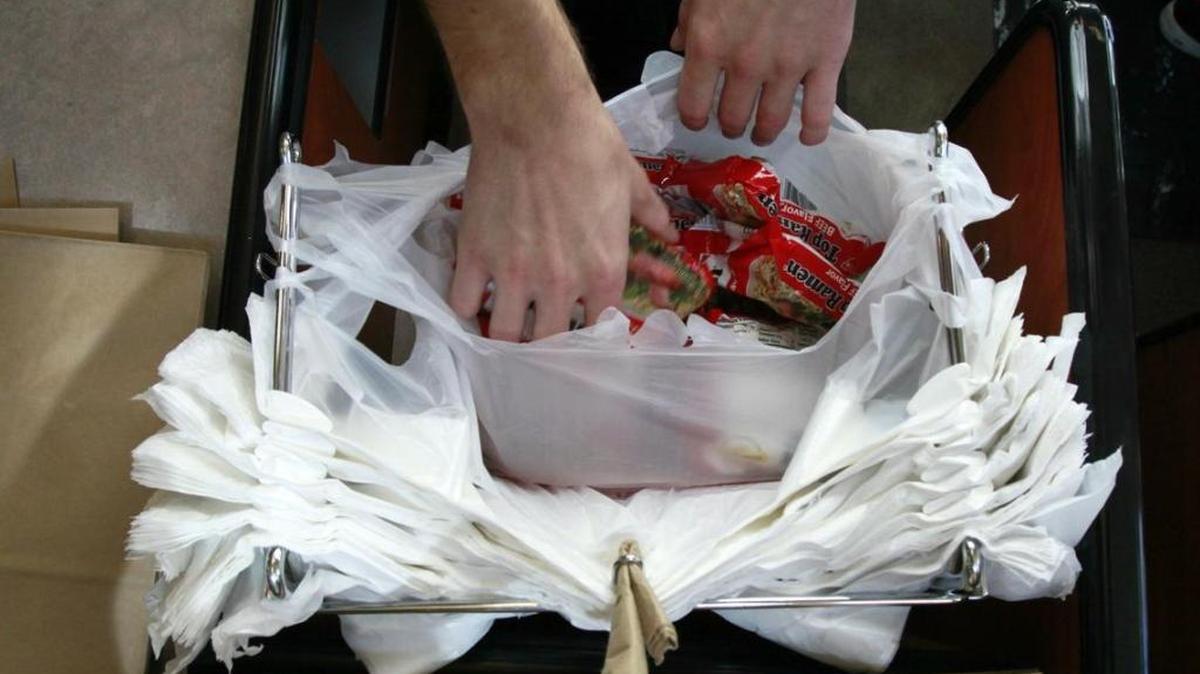 This 2009 photo shows a clerk bagging groceries in plastic sacks. The Idaho Legislature is considering making it illegal for cities to impose bag bans, restrictions on Styrofoam containers and other disposable products.