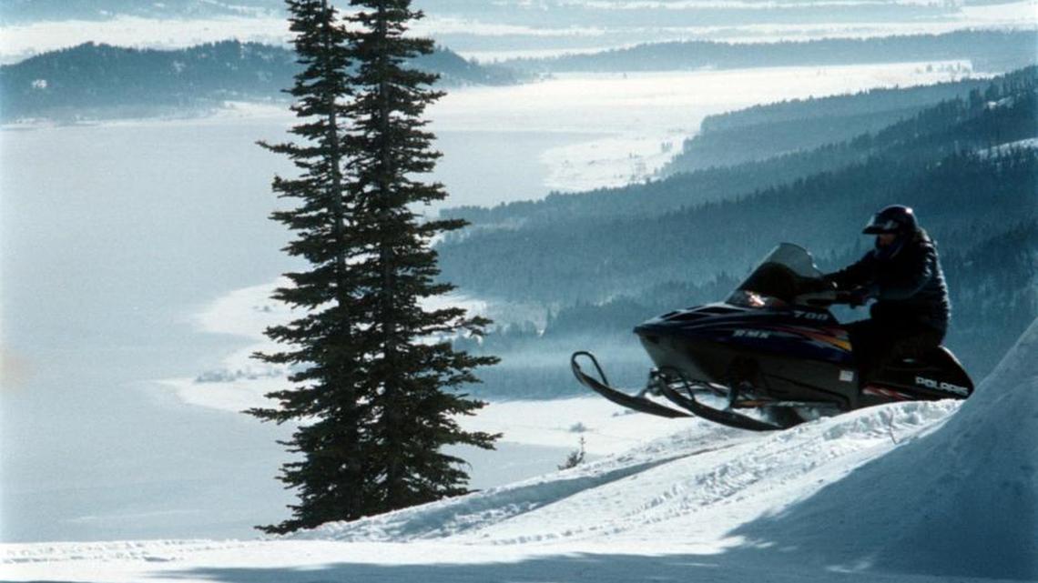 A snowmobiler plays on West Mountain overlooking Cascade Reservoir accessed by Valley County’s snowmobile groomed trails which will be shut off by new owners of the private forest there.