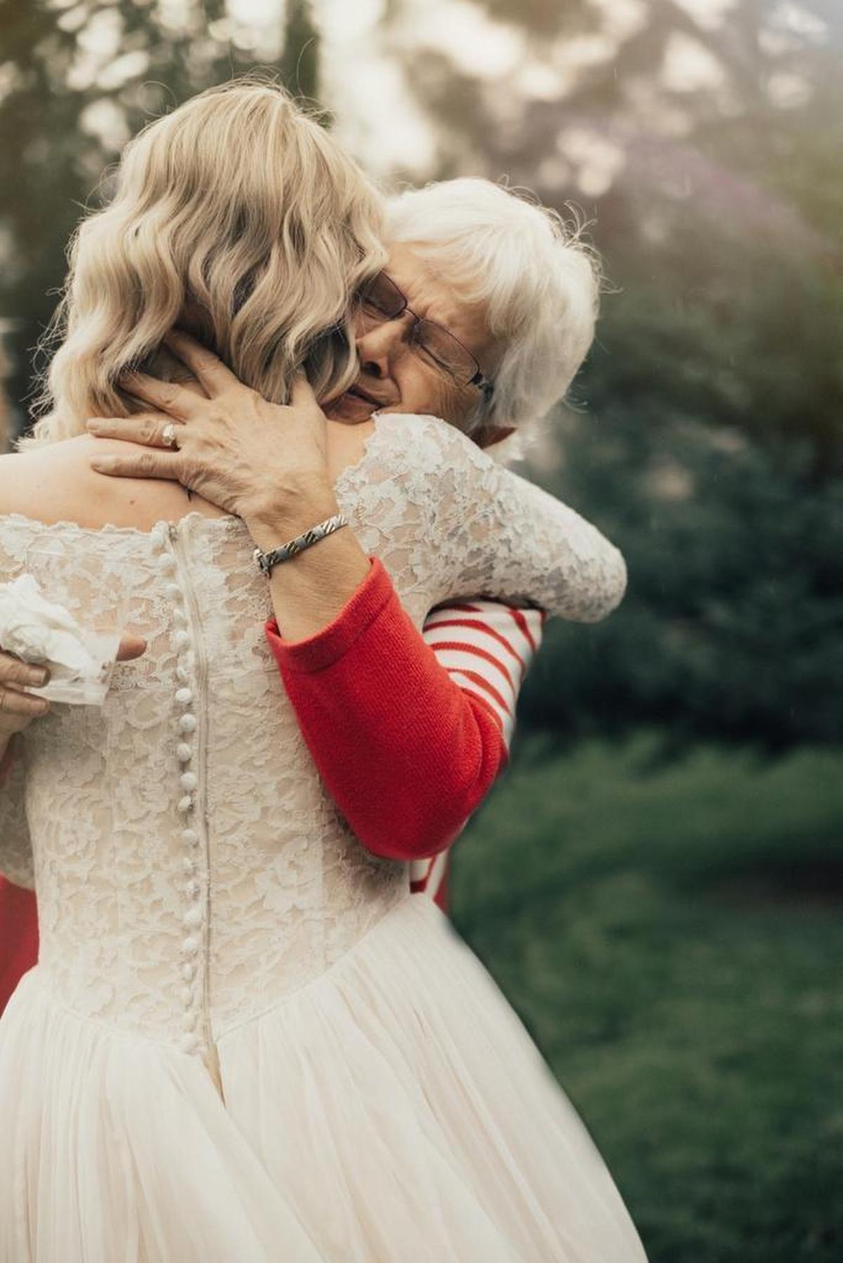 Penny Jensen, 74, hugs her granddaughter Jordyn after learning her granddaughter would wear Penny’s 1962 wedding gown.