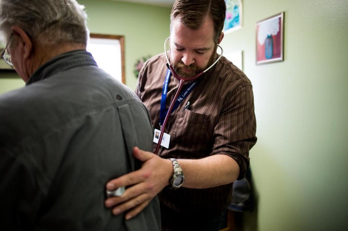 Dr. Orie Browne examines Hammond Britton of Moore.