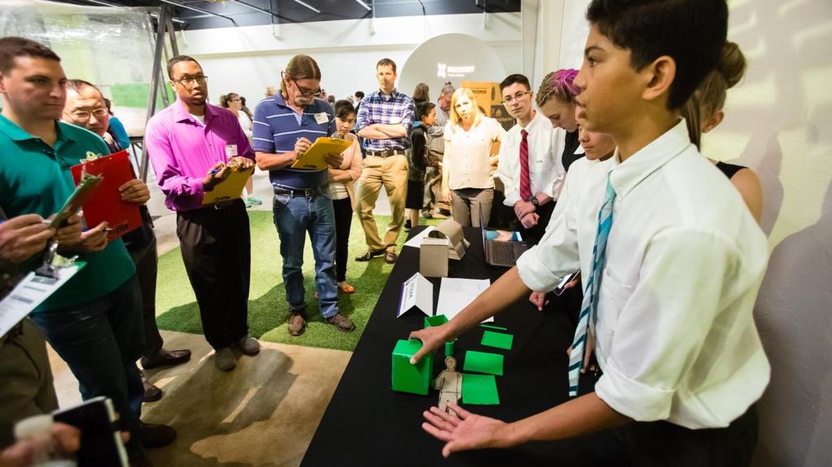 Micah Erickson, an 8th grader at Lone Star Middle School in Nampa and G T.E.A.M. member, discusses their H.E.L.P (Homeless Emergency Life Pack) design for the judges at the 2016 FabSLAM Idaho Showcase at the Discovery Center of Idaho in Boise, Idaho, on Saturday, May 14, 2016. The FabSLAM Showcase was the conclusion of a 3D printing design and fabrication competition featuring teams from schools around Idaho conducted by the Idaho STEM Action Center. The G T.E.A.M. took both first place and the student award.
