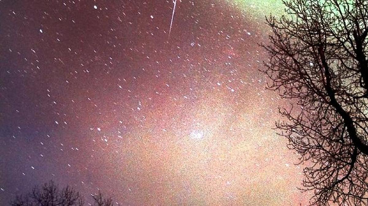 A meteor shows up against the aurora borealis near Homer, Alaska, in this 1998 photo. It was part of the Leonid meteor showers, which are impressive as Earth passes through the tail of the comet Tempel-Tuttle.
