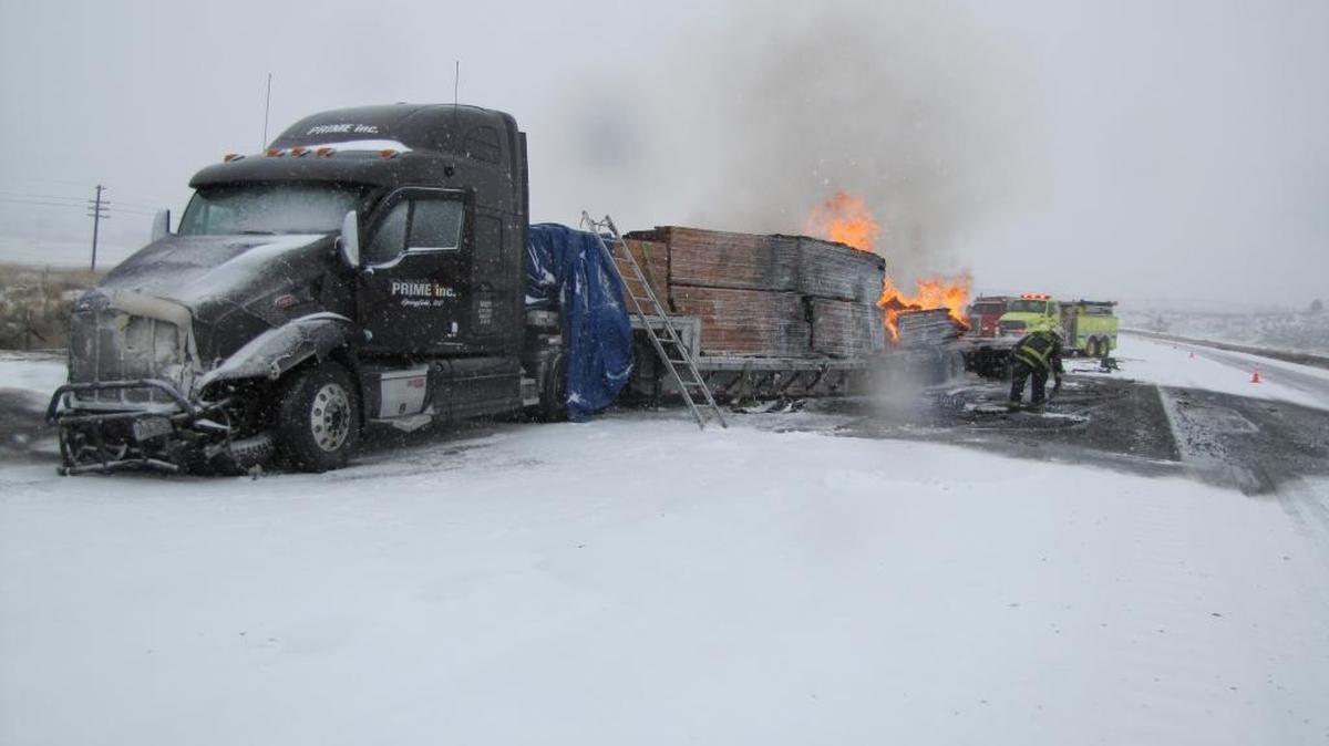 Fire engulfs the back of a semi trailer following a fatal crash Thursday morning just east of Durkee, Ore. A Wendall woman and a 12-year-old girl riding with her were killed after their Chevy Suburban slid on ice and struck the semi head-on.
