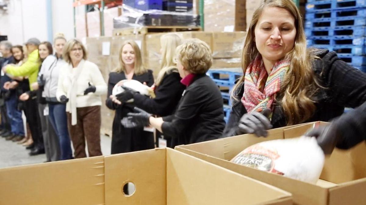 Kami Faylor, community relations manager at Micron Technology, heads a line of Micron employees as they unload turkeys at The Idaho Foodbank. Micron employees donated 1,245 turkeys and 285 hams on Nov. 17 — their 14th year with a large donation to the nonprofit.