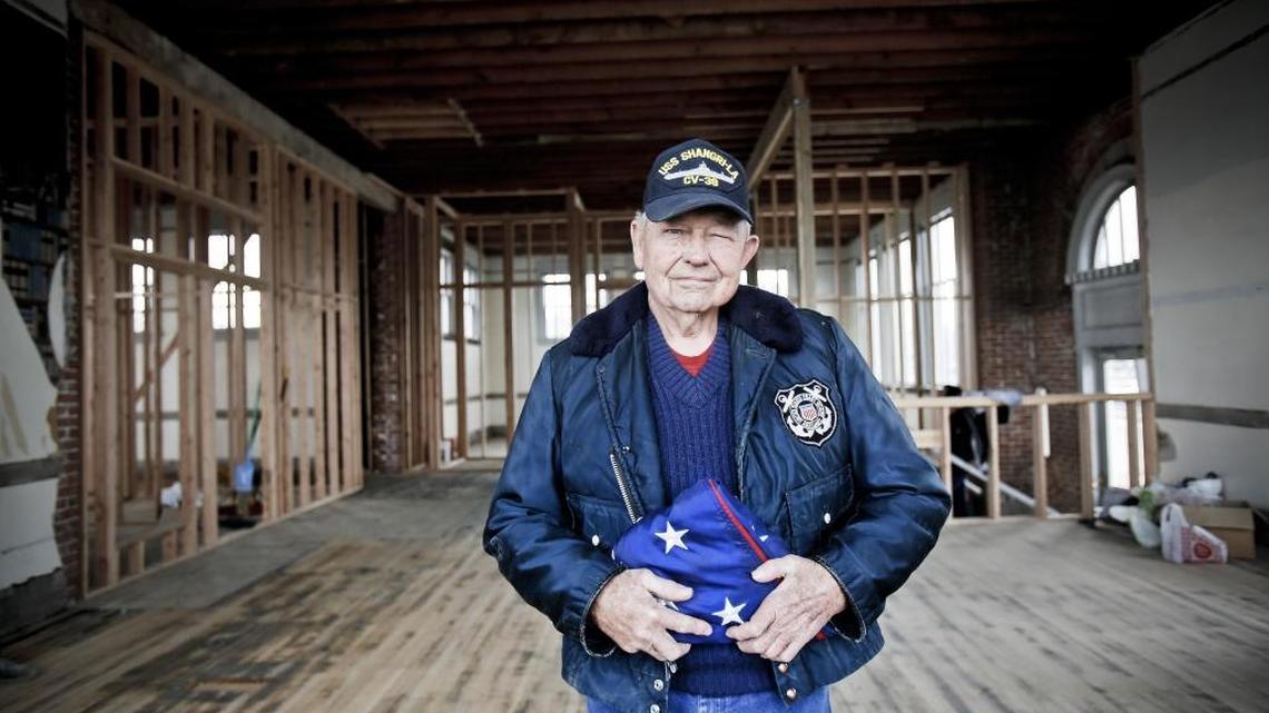 Larry Kelly, a Navy veteran who served in the Korean War, holds a flag that will fly from the century-old flagpole at the Caldwell Veterans Memorial Hall.