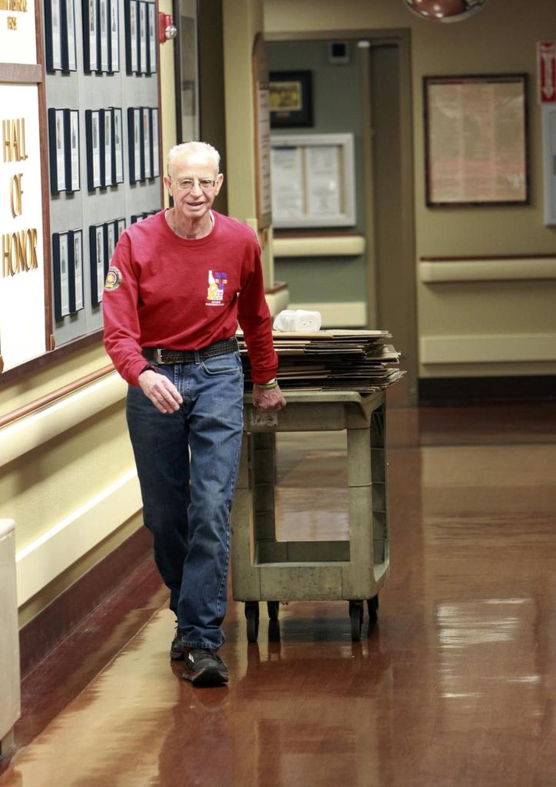Phil Hawkins brings in cardboard boxes to package clothing bundles for homeless veterans in the halls of the Idaho State Veterans Home.