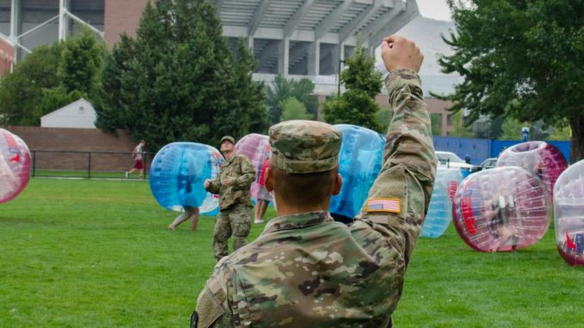 Two National Guardsmen play catch during military appreciation day on the Boise State campus.