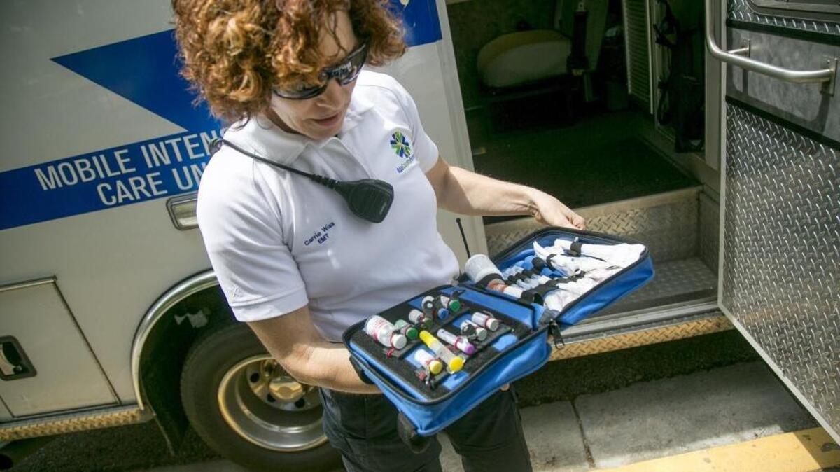 EMT-A Carrie Wiss of Ada County Paramedics opens a medical bag containing naloxone, used to reverse the effects of opioids in an overdose situation.