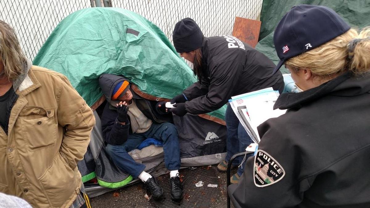 Boise police hand out claims tickets to Cooper Court residents Friday.