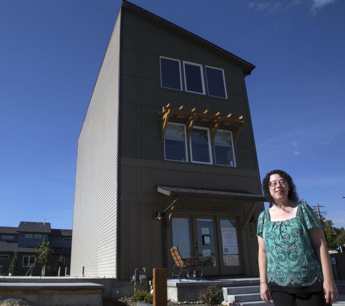 Angela Bauter is the first person to move into a live/work neighborhood on 36th Street in Garden City. She operates her graphic design business on the ground floor. She, and her extended family, including two nieces and nephews, live on the two floors upstairs.