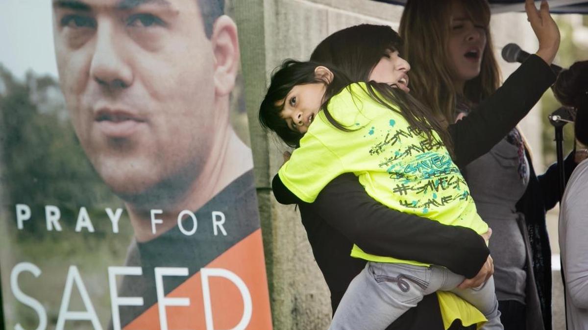 Nagmeh Abedini holds her daugher Rebekka, then 7, during a 2013 prayer vigil seeking freedom for her husband, Boise pastor Saeed Abedini, who had been arrested in Iran.