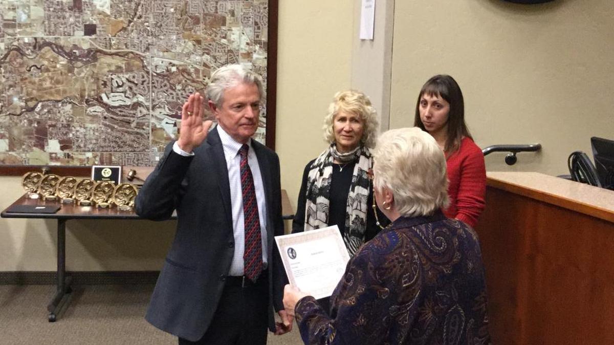 New Eagle Mayor Stan Ridgeway takes the oath of office Tuesday night with his wife, Margie, and his daughter, Alicia Baptiste, far right.