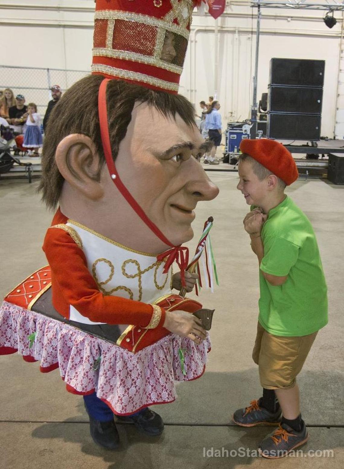 Mateo Wilsex, 6, with Herribatza Dantzariak from Homedale, taunts Zamaltzain, a giant character from Basque masquerades at the 2016 Jaialdi. The festival, postponed in 2020 because of the coronavirus pandemic, is scheduled to take place in July 2021.